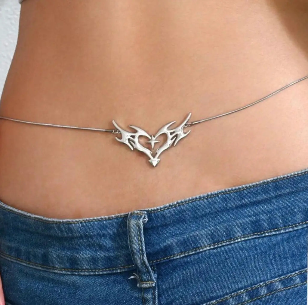 Lower back tattoo tribal heart body chain